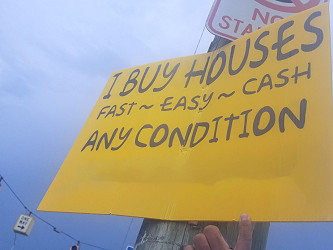 What's With All Those Shady 'We Buy Houses' Signs?
